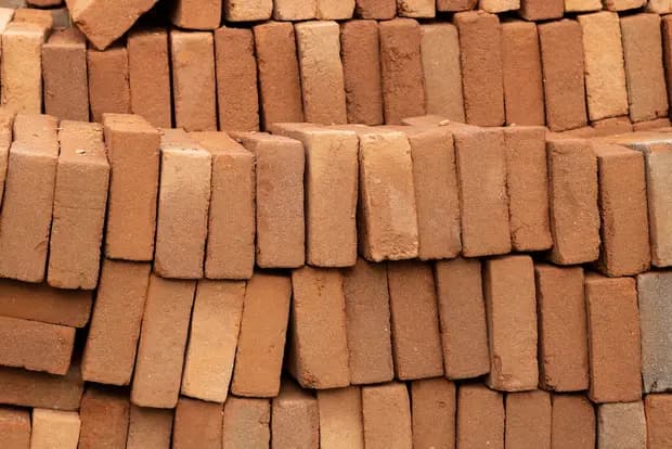 Neatly stacked clay bricks