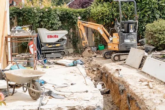 Groundworks under way with an excavator on site