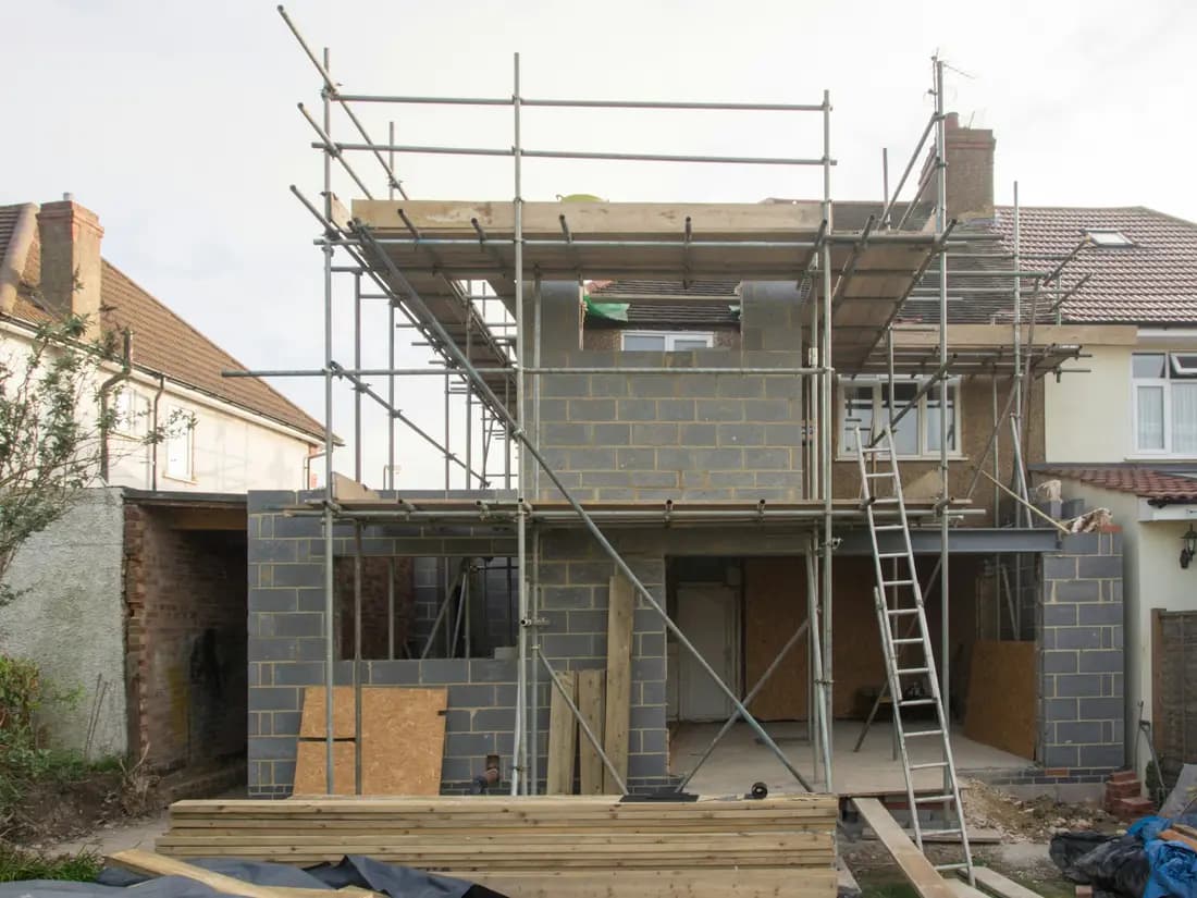 A house under construction with scaffolding up