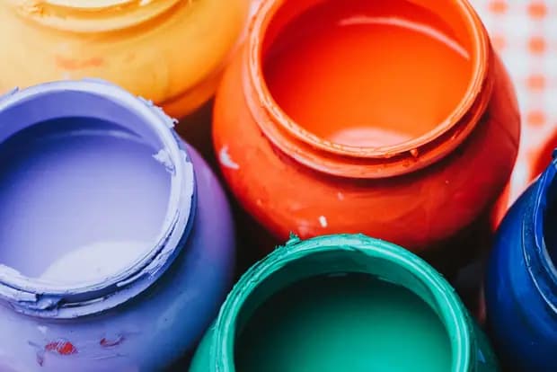 Open tins of coloured paint