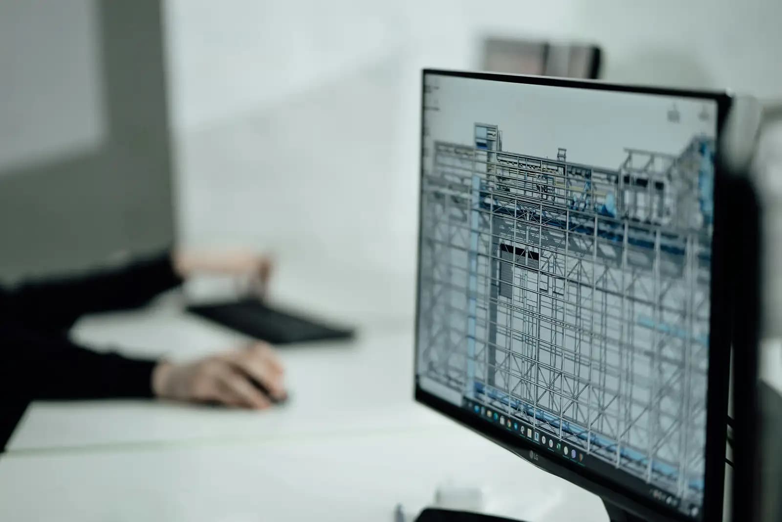 A structural drawing on a monitor at a drawing desk